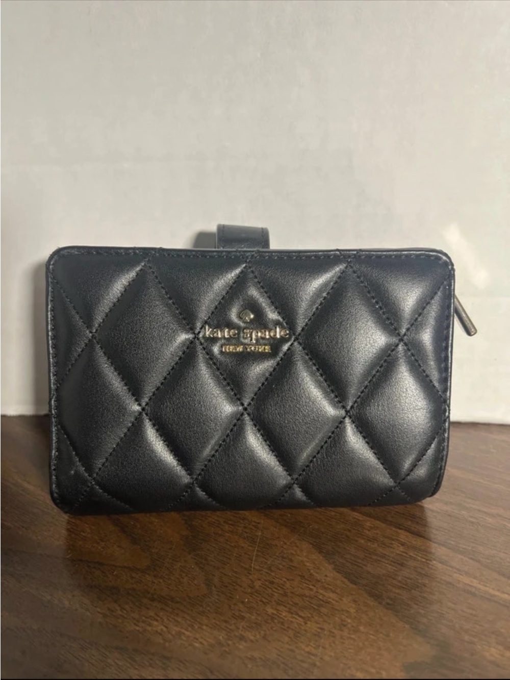 kate spade black quilted leather zip-around wallet with gold logo